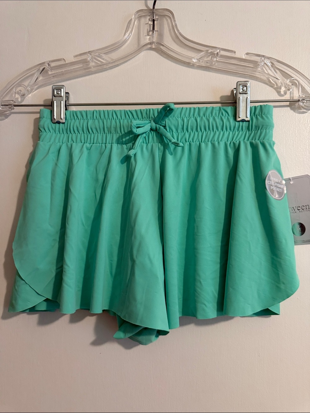 Pair of Girls btween Flowy Shorts with elastic waist. Mint/black